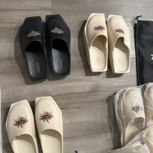 Three pairs of slides with a sun design on each.